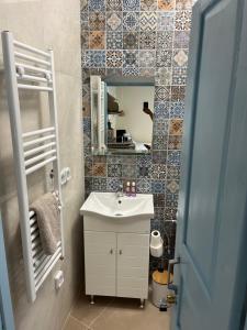 W łazience znajduje się umywalka i lustro. w obiekcie Dream House Little Villa - Amorgos w mieście Amorgós