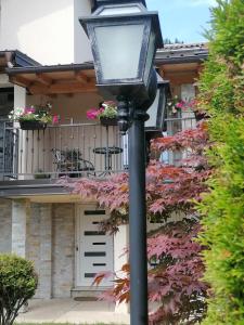 a street light in front of a house with flowers at Villa Bozovic in Zlatibor