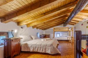 a bedroom with a large bed and a mirror at Baita Margherita - Val Veny in Courmayeur