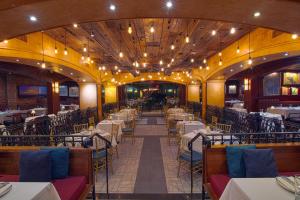 a restaurant with tables and chairs and a ceiling with lights at Hotel Edison Times Square in New York