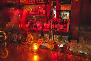 a bar with a bunch of glasses on a counter at Hotel Edison Times Square in New York