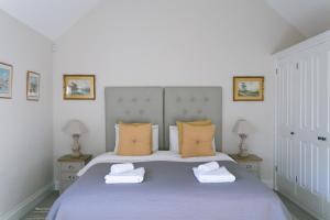 a bedroom with a bed with two towels on it at Stay on the Hill - Self Catered Cottages Laverick and Bothy in Hexham