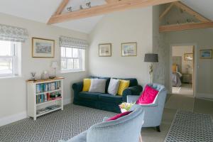 a living room with a green couch and two chairs at Stay on the Hill - Self Catered Cottages Laverick and Bothy in Hexham
