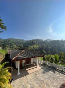 a house with a view of the mountains at Escape Ella Bungalow in Bandarawela