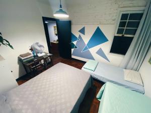 Ένα ή περισσότερα κρεβάτια σε δωμάτιο στο NeighborHUB hostel e coliving