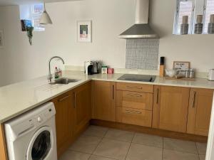 a kitchen with a washing machine and a sink at 10A Ruston Chambers Free parking, Luxury 2 bedroom city center apartment in St Ives