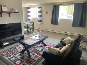 a living room with a couch and a coffee table at One Bedroom Main floor Apartment in Camrose