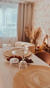 a table with plates and glasses on top of it at Bohemian in Šamorín