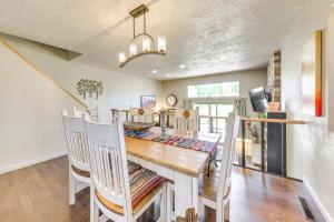 a dining room with a wooden table and chairs at Ruidoso Golf Condo - Patio, Fire Pit and Mtn View! in Ruidoso