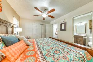 a bedroom with a bed and a ceiling fan at Ruidoso Golf Condo - Patio, Fire Pit and Mtn View! in Ruidoso