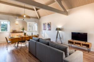 a living room with a couch and a table at Feel Discovery Homes in Douro in Peso da Régua