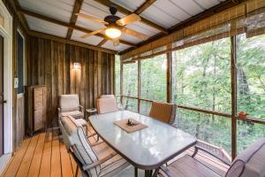 a screened in porch with a table and chairs at Lake Cumberland Resort Cabin with Community Perks! in Burnside