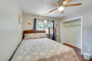 a bedroom with a bed with a ceiling fan at Pet-Friendly Medford Vacation Rental with Yard! in Medford