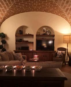 a living room with a couch and a tv at JOHN's Farm Country HOUSE in Montemor-o-Novo