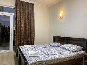 En eller flere senge i et værelse på Hotel Neli