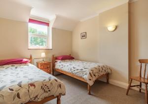a bedroom with two beds and a window at Fieldview in East Barsham