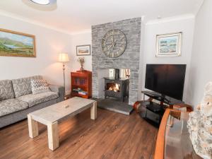 a living room with a couch and a fireplace at 17 Clover Hill in Killorglin