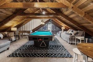 a living room with a pool table in the attic at Rustic Cabin, Dock, Firepit, Kayaks & Games in Winchester