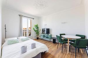 a bedroom with a bed and a table and chairs at Modern&Confort Fully Furnish Apartment ⭑ La Défense ⭑Champs Elysées⭑ RER A & L in Maisons-Laffitte