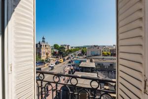 a view of a city street from a balcony at Modern&Confort Fully Furnish Apartment ⭑ La Défense ⭑Champs Elysées⭑ RER A & L in Maisons-Laffitte