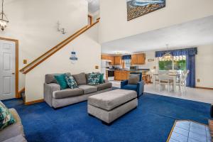 a living room with a couch and a table at 20 Victoria Lane Dennis Cape Cod - 5 O'Clock Somewhere in Dennis