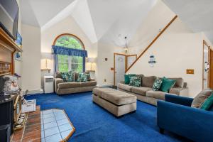 a living room with two couches and a blue carpet at 20 Victoria Lane Dennis Cape Cod - 5 O'Clock Somewhere in Dennis
