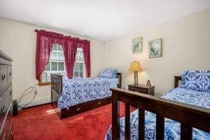 a bedroom with two beds and a window at 20 Victoria Lane Dennis Cape Cod - 5 O'Clock Somewhere in Dennis