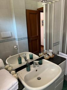 uma casa de banho com um lavatório branco e um espelho. em EASHOME EUR Mostacciano Bilocale adiacente IFO em Mostacciano
