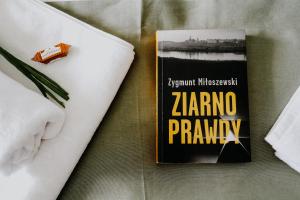 książka siedząca na łóżku obok serwetki w obiekcie Apartament Miasto i Wisła w mieście Sandomierz +32 zdjęcia