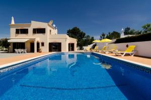 a swimming pool in front of a villa at Villa with Private Pool Near Benagil & Marinha Beach in Lagoa