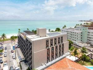 an aerial view of a building in front of the ocean at Arpoar Suítes by Slaviero Hotéis in João Pessoa