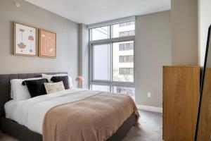 a bedroom with a large bed and a large window at Bethesda 2br w wd gym pool nr dining WDC-661 in Bethesda