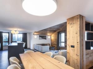 a dining room with a wooden table and chairs at Appartement Courchevel 1650, 3 pièces, 6 personnes - FR-1-618-33 in Courchevel
