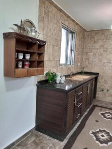 a bathroom with a sink and a counter top at Simple home in Madaba