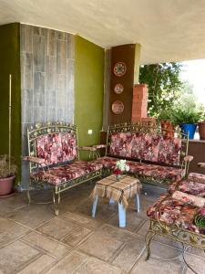a room with three beds and a table and chairs at Simple home in Madaba