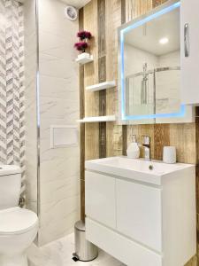 a bathroom with a white sink and a mirror at Colourful Apartment for 4 Guests and Free Parking in Stara Zagora