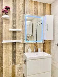 a bathroom with a white sink and a mirror at Colourful Apartment for 4 Guests and Free Parking in Stara Zagora