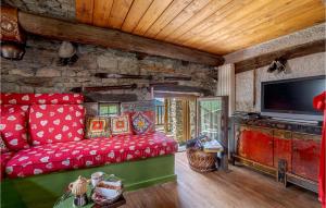 a living room with a red couch and a tv at Casa Del Pepe in Chamois
