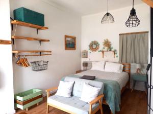 a bedroom with a bed and a bench at Ethic Surf House in Ferrel