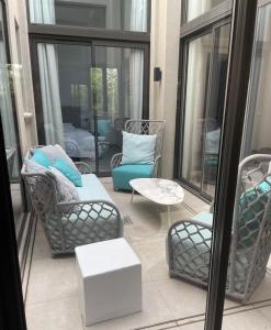 a screened in porch with chairs and a table at Les Orangers by Sezz in Saint-Tropez