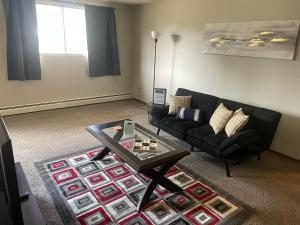 a living room with a couch and a coffee table at One Bedroom Main floor Apartment in Camrose