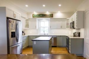 a kitchen with white cabinets and a sign that reads look promise at Waterfront with Hot Tub Joanie's Farmhouse in Bath