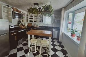 a kitchen with a black and white checkered floor at Rustic Modern Home and Spa in Hillier