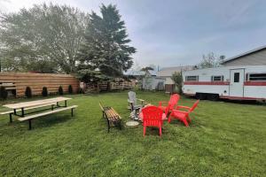 a group of chairs and a picnic table in a yard at Rustic Modern Home and Spa in Hillier