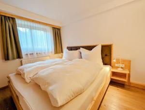 A bed or beds in a room at Das Wipferl - Dein Nest in den Bergen