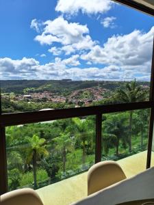 a view from the balcony of a house with chairs at Aconchegante apartamento studio em Bananeiras in Bananeiras