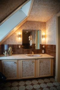 a bathroom with a sink and a large mirror at Hotel Tanum Gestgifveri in Tanumshede