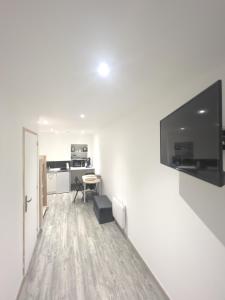 a living room with a flat screen tv on a wall at Au domaine des roches in Saint-Pierre-sur-Dives
