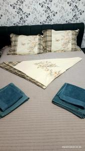 a bed with towels and pillows on it at Natural House in Constanţa