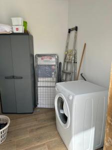 a laundry room with a washing machine and a refrigerator at Chozos Cottage by VV Canary Ocean Homes in Las Cruces